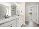 The Main bathroom has dual vanities with granite counters, white cabinets, and modern faucets at 172 Royal Ave, Selma, NC 27576