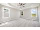 The Main bedroom features a tray ceiling with ceiling fan and three large windows at 172 Royal Ave, Selma, NC 27576
