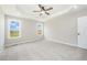 Large bedroom with tray ceiling, ceiling fan, and views from the windows at 172 Royal Ave, Selma, NC 27576