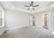 Spacious bedroom with tray ceiling, ceiling fan, and connecting door to bathroom at 172 Royal Ave, Selma, NC 27576
