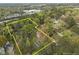 Aerial view of a large lot surrounded by trees, featuring a home and an additional building within property lines at 1823 E Geer St, Durham, NC 27704