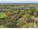 An aerial perspective reveals a property with various buildings surrounded by a landscape full of trees at 1823 E Geer St, Durham, NC 27704