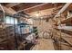 Unfinished basement with shelving units, stone wall and small window at 1823 E Geer St, Durham, NC 27704