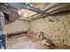 Unfinished basement with exposed beams, a small window and a concrete floor at 1823 E Geer St, Durham, NC 27704
