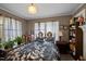 Cozy bedroom with patterned bedding and an antique-style bedside table at 1823 E Geer St, Durham, NC 27704