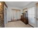 Cozy bedroom with stone accent wall, natural light, and charming decor at 1823 E Geer St, Durham, NC 27704