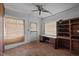 Bedroom featuring a ceiling fan, desk, and built-in shelving, perfect for a home office at 1823 E Geer St, Durham, NC 27704
