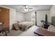 Cozy bedroom with a ceiling fan, plush carpet, and a bright window view at 1823 E Geer St, Durham, NC 27704