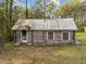 Log cabin exterior exhibiting its classic architecture and picturesque natural setting at 1823 E Geer St, Durham, NC 27704