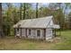 Charming log cabin exterior with a weathered roof, exuding rustic appeal and timeless character at 1823 E Geer St, Durham, NC 27704