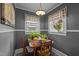 Bright dining area with dual windows, grey walls, and quaint furnishings at 1823 E Geer St, Durham, NC 27704