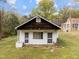 Exterior view of a detached building with a white brick foundation and a dark wooden roof at 1823 E Geer St, Durham, NC 27704
