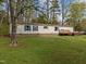 Charming manufactured home with blue shutters and a spacious front yard at 1823 E Geer St, Durham, NC 27704