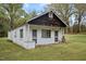 Exterior view of a detached white building with dark wood paneling at 1823 E Geer St, Durham, NC 27704