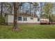 Well-maintained mobile home featuring a green lawn and a deck at 1823 E Geer St, Durham, NC 27704