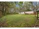 Spacious lawn with house in the background, complemented by lush trees and natural surroundings at 1823 E Geer St, Durham, NC 27704