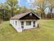 Exterior view of a detached building with a white brick foundation and a dark wooden roof at 1823 E Geer St, Durham, NC 27704