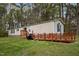 Attractive manufactured home with a front deck and manicured lawn at 1823 E Geer St, Durham, NC 27704