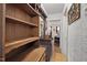 Hallway with wooden shelves and mirror leading to an adjacent room at 1823 E Geer St, Durham, NC 27704