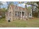 Stone home with a brown roof and front porch set on a grassy yard at 1823 E Geer St, Durham, NC 27704