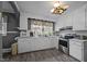 Bright kitchen boasts white cabinets, grey walls, stainless appliances, and luxury vinyl plank flooring at 1823 E Geer St, Durham, NC 27704