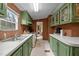 Bright kitchen featuring green cabinets, white countertops, and stainless steel sink at 1823 E Geer St, Durham, NC 27704