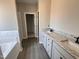 Bathroom featuring double sinks with granite countertops and tub at 192 Royal Ave, Selma, NC 27576