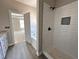 Bright bathroom featuring a walk-in shower with subway tile and a separate soaking tub at 192 Royal Ave, Selma, NC 27576