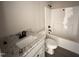 Clean bathroom with granite countertop, white cabinets, and a tub-shower combo at 192 Royal Ave, Selma, NC 27576