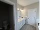 Well-lit bathroom with dual vanity sinks and a private toilet area at 192 Royal Ave, Selma, NC 27576