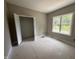 Another bright bedroom view, featuring a large window, with a view and an adjacent closet space at 192 Royal Ave, Selma, NC 27576