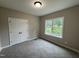 This bedroom features soft carpet, a double-door closet, and a window for natural light at 192 Royal Ave, Selma, NC 27576