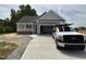 Charming single-story home featuring a covered porch, attached garage, and freshly poured concrete driveway at 192 Royal Ave, Selma, NC 27576