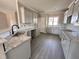 Bright kitchen featuring new cabinets, a stylish faucet, and granite countertops at 192 Royal Ave, Selma, NC 27576