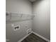 Functional laundry area with wood-look flooring and wire shelving at 192 Royal Ave, Selma, NC 27576