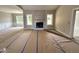 Inviting living room with a fireplace and ample natural light from the surrounding windows at 192 Royal Ave, Selma, NC 27576