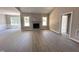 Spacious living room with large windows, a fireplace, and light wood flooring at 192 Royal Ave, Selma, NC 27576