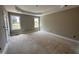 Serene primary bedroom with tray ceilings, a light-filled windows, and a private ensuite at 192 Royal Ave, Selma, NC 27576