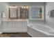 Bathroom with double vanity, jacuzzi tub and tile shower at 2002 Patapsco Dr, Apex, NC 27523