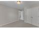 Neutral bedroom with plush carpet, double closets, and entry to another room; simple and bright at 2002 Patapsco Dr, Apex, NC 27523