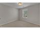Empty bedroom with neutral walls and carpet, natural light from window, and a simple, clean design at 2002 Patapsco Dr, Apex, NC 27523