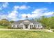 Exterior shot of the single-story white clubhouse with manicured lawn and shrubs at 2002 Patapsco Dr, Apex, NC 27523