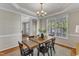 This formal dining room has an elegant chandelier and decorative molding around the ceiling at 2002 Patapsco Dr, Apex, NC 27523