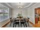 An elegantly staged dining room area is lit by a modern chandelier and has a large bay window at 2002 Patapsco Dr, Apex, NC 27523