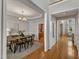 Elegant dining room featuring hardwood floors, decorative lighting, and neutral walls at 2002 Patapsco Dr, Apex, NC 27523
