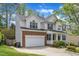 Traditional two-story home featuring a brick-accented garage and manicured landscaping at 2002 Patapsco Dr, Apex, NC 27523