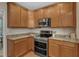 Kitchen with stainless steel appliances, granite countertops, and wood cabinets with a modern range at 2002 Patapsco Dr, Apex, NC 27523