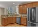 Bright kitchen with stainless appliances, granite countertops, and hardwood flooring plus a large window at 2002 Patapsco Dr, Apex, NC 27523