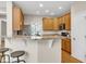 Eat-in kitchen with granite countertops, stainless steel appliances, wood cabinets, and breakfast bar seating at 2002 Patapsco Dr, Apex, NC 27523