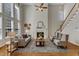 Open living room is bright with tall windows and has a cozy fireplace with a mantel at 2002 Patapsco Dr, Apex, NC 27523